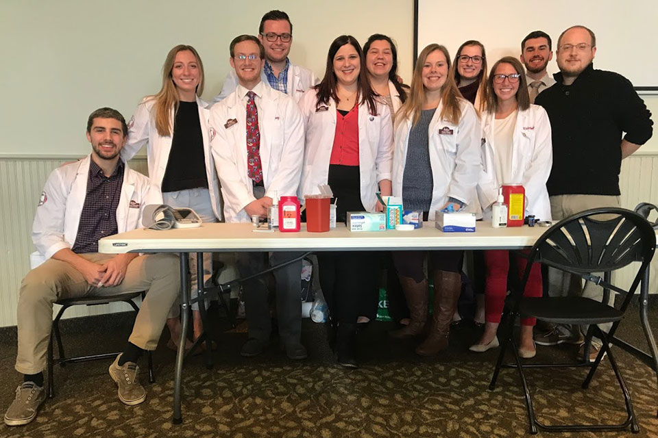 Members of Phi Delta Chi host a health fair.