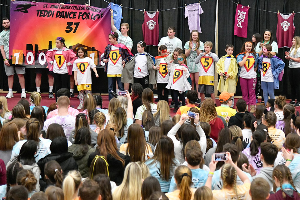 Children from Camp Good Days and Special Times help reveal the total of $100,395.18 raised during the 2019 Teddi Dance for Love.
