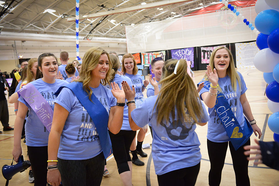 Dancers run into the field house to kick off Teddi 36.