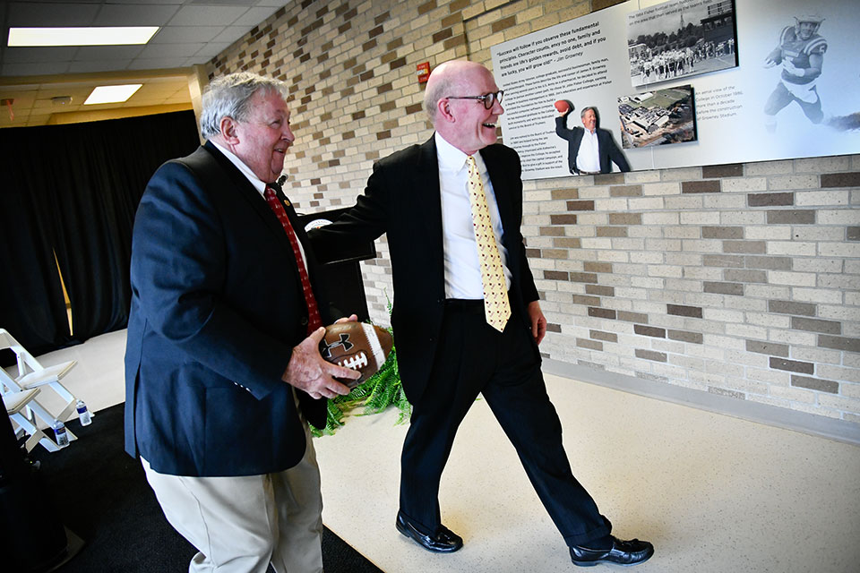 Jim Growney and President Rooney view the new display commemorating the anniversary of Growney Stadium's construction.