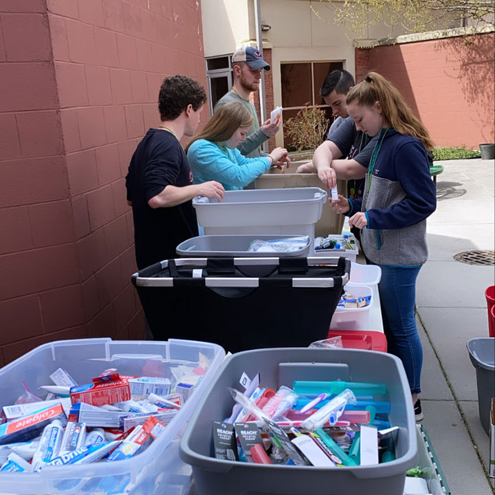 Students sort items at a service site.