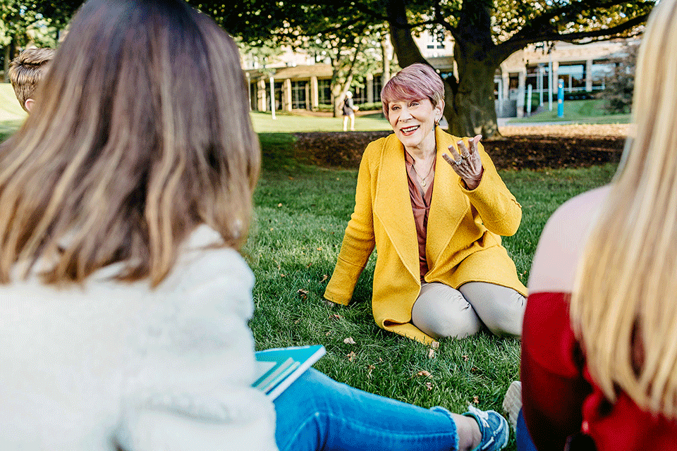 Dr. Carolyn Vacca teaches a class outside on a warm fall day.