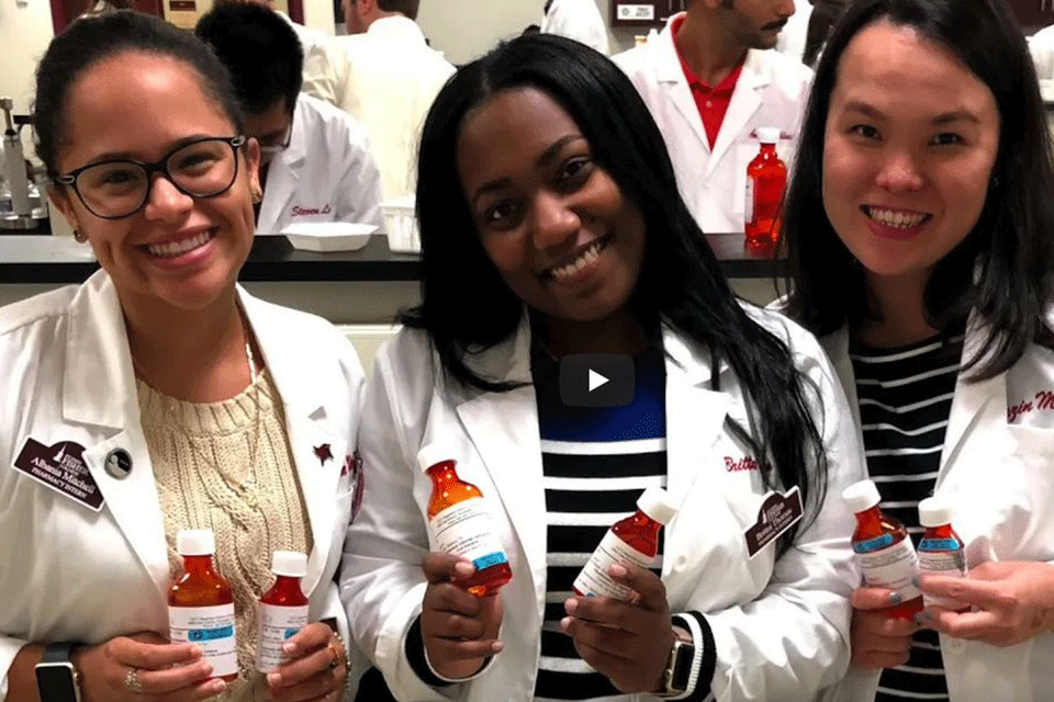 Albania Mitchell (left) with two classmates from the Wegmans School of Pharmacy.