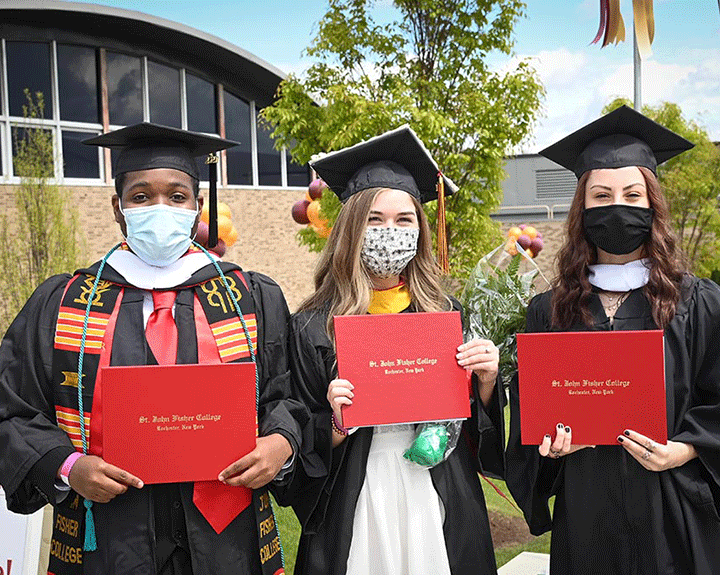 New graduates of the School of Arts and Sciences show off their diplomas.