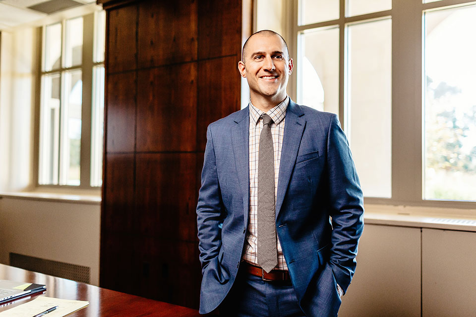 A MBA student presents in a boardroom.