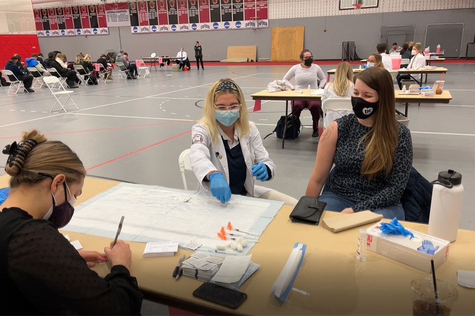 Members of the Wegmans School of Pharmacy administer COVID vaccines to students and employees.