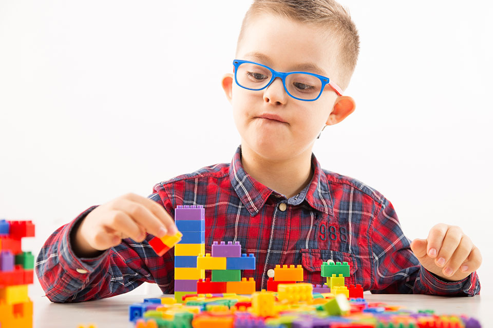 A child with a developmental disability engages in motor therapy.