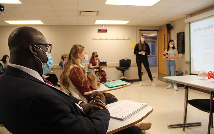 Dr. Marlowe Washington listens as students present their DEI recommendations for Fisher.