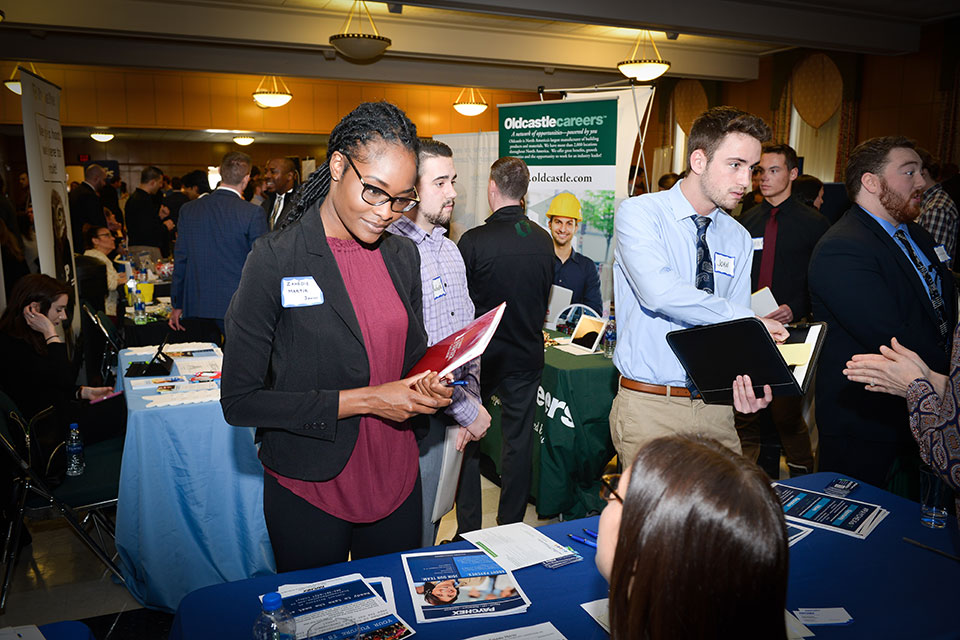 A student chats with a potential employer at the Career Fair.