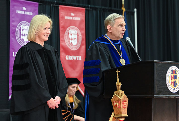 Provost Kevin Railey presents Mary Davis, CEO of Special Olympics International, with an honorary degree.