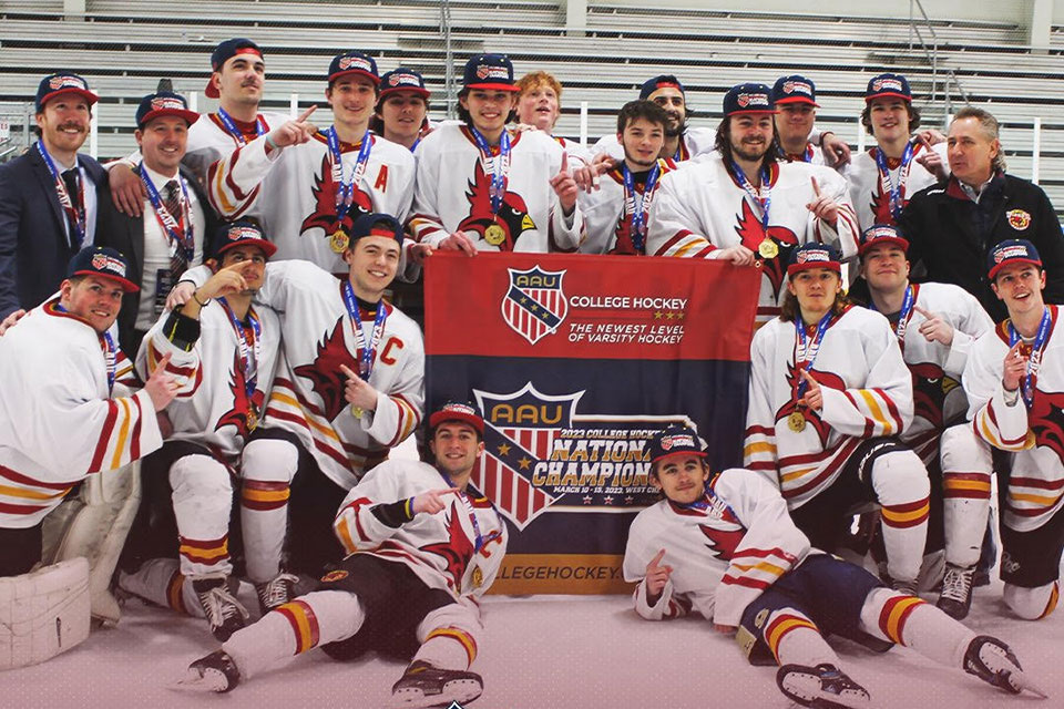 Members of Fisher's club hockey team with the national championship banner.