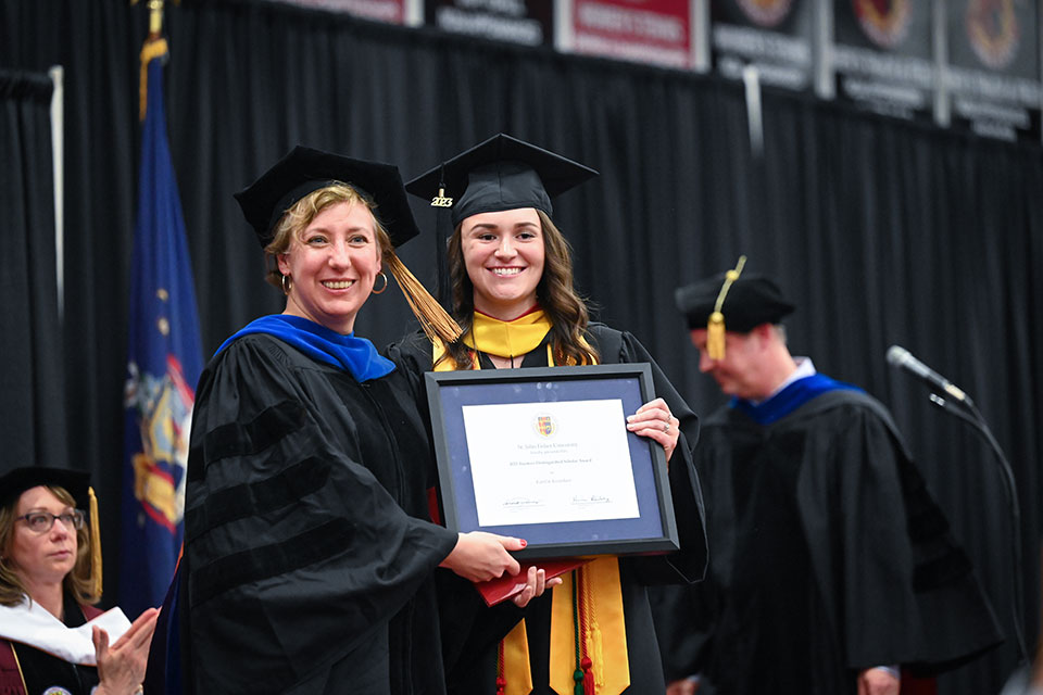 Dean Ann Marie Fallon presents Katelin Keenehan with a Trustees Distinguished Scholar Award.