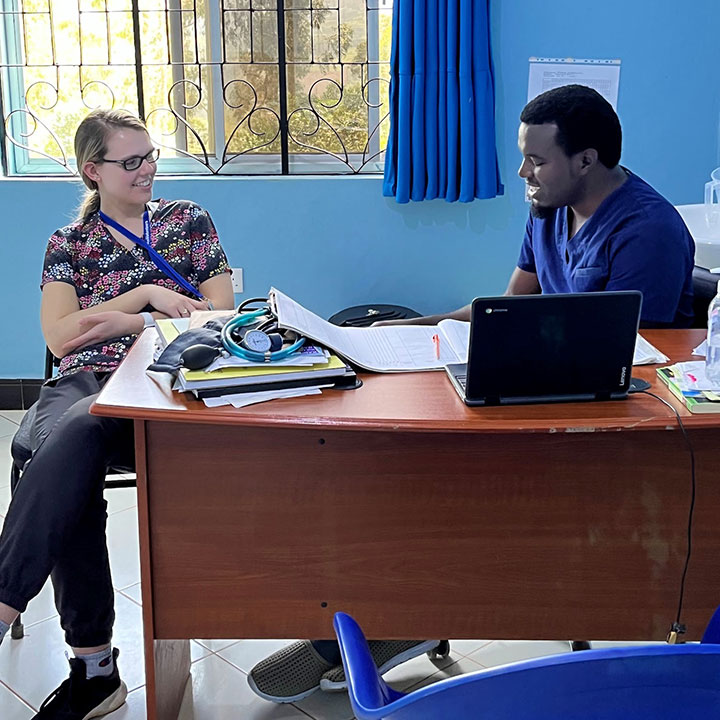 Sara Riforgiat consults with a clinic physician during her time in Tanzania.