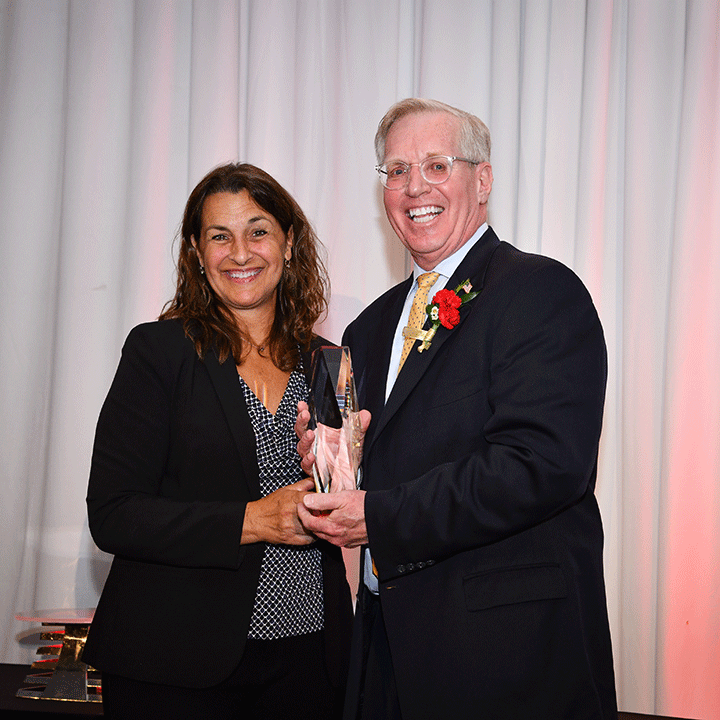 Cheryl Yawman presents the Alumnus of the Year Award to John Barden.