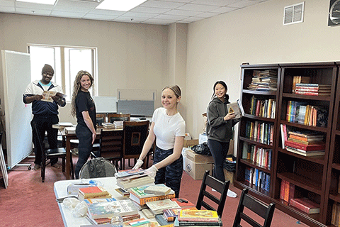 Students sort books at the Hindu Temple of Rochester.