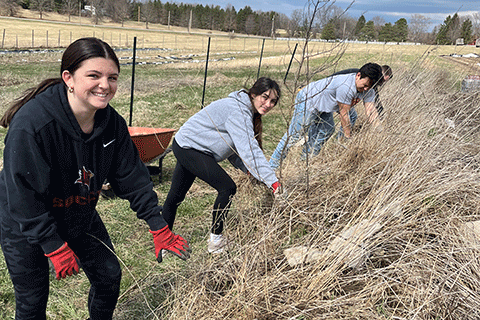 Students tend to a garden at the EquiCenter.