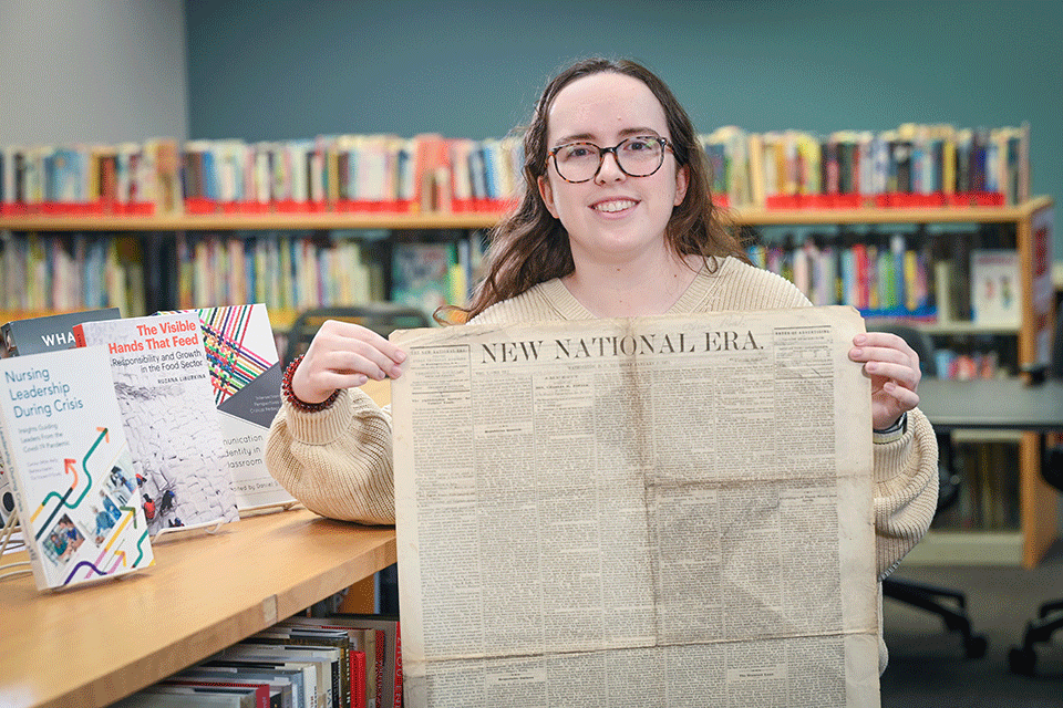Shannon Feeley poses with the issue of New National Era.