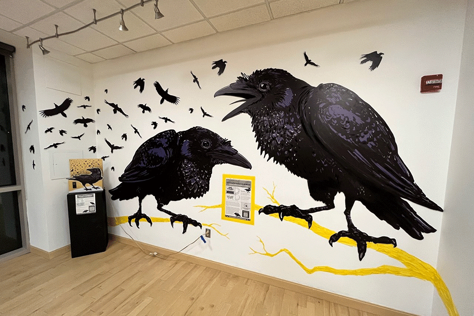 A large mural of Rochester's famous crows at the Urban Alchemy exhibit.