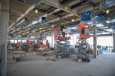 Construction crew members work on ceiling beams on the second floor of Lavery Library.