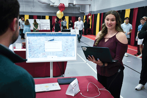 A student showing research during the annual Fisher Showcase