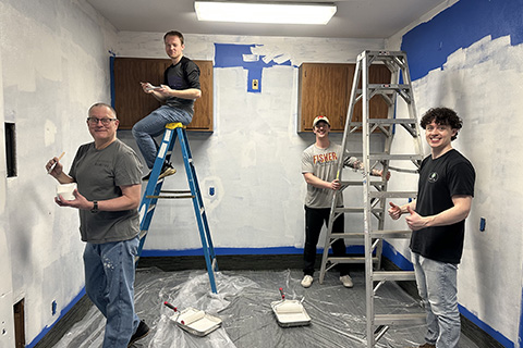 Group of pharmacy students painting during the annual Service Day.