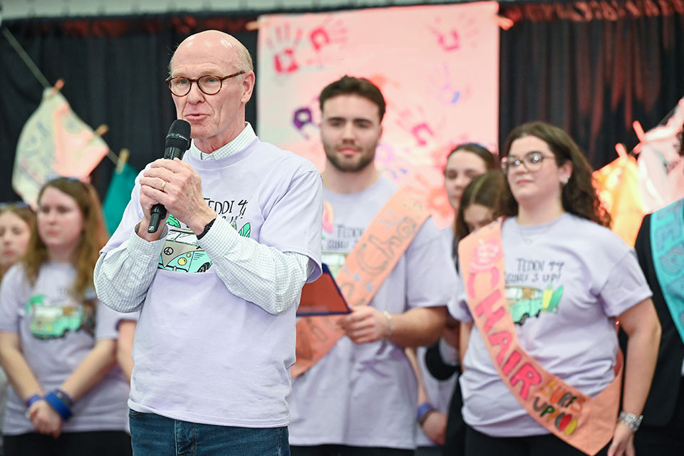 President Rooney addressing the dancers from the stage