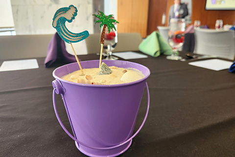 Centerpieces at the Very Beary Brunch include buckets of sand for the Surfs Up theme.