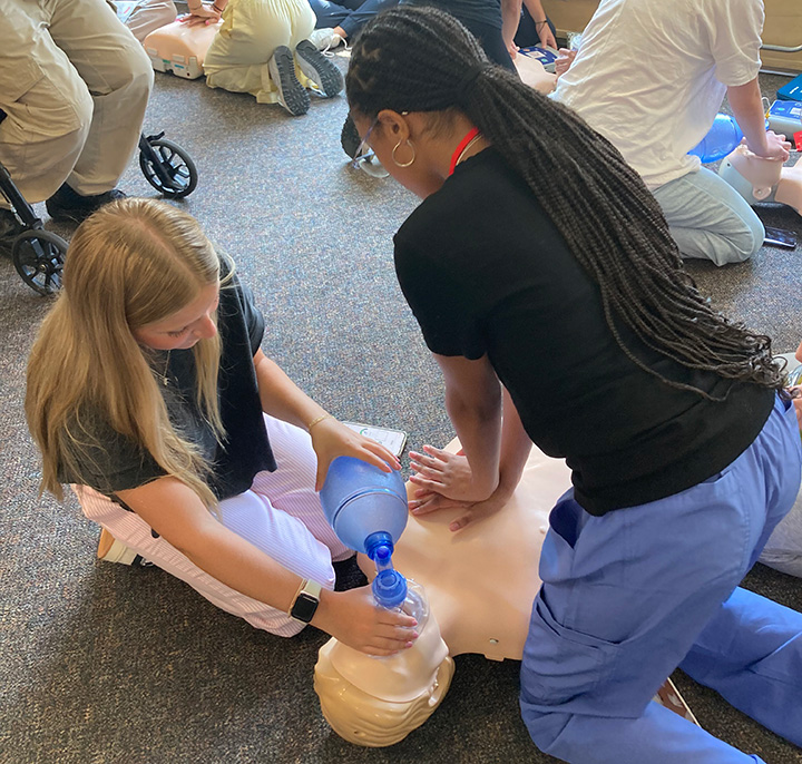 Students practice CPR skills during Cardinal Nurse Camp and Pharmacy Camp.