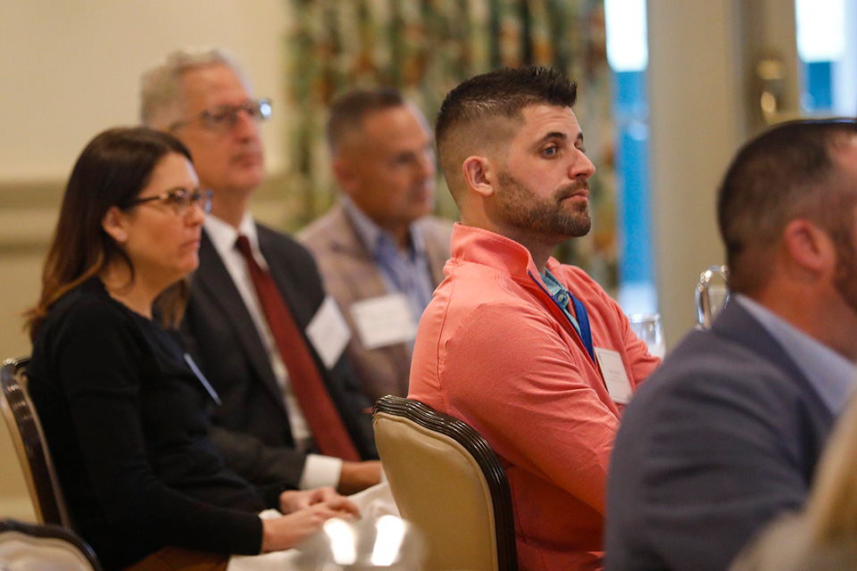 Attendees at a Family Business event listen to a speaker.