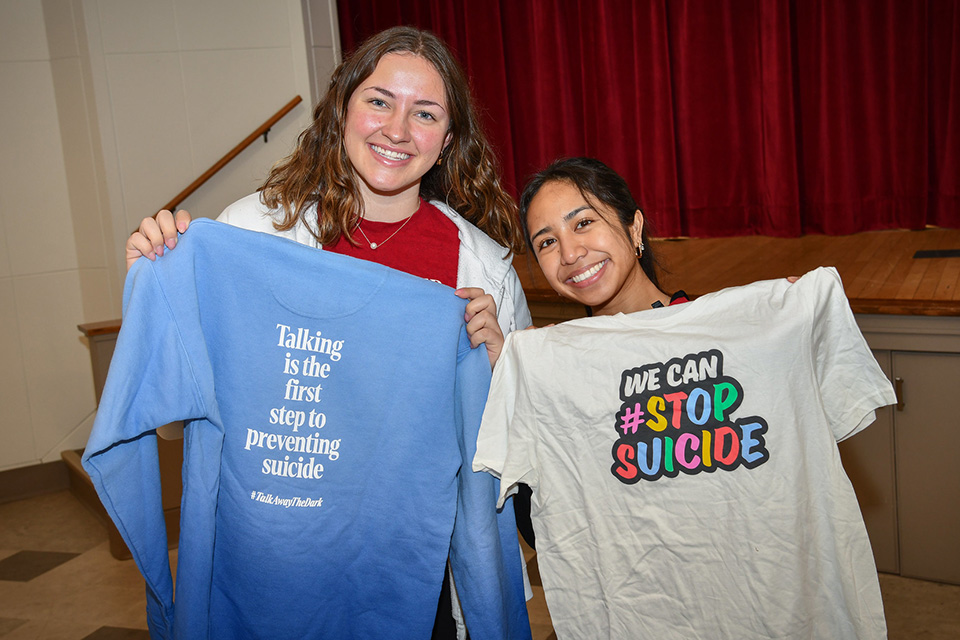 Walk participants hold shirts to raise awareness of suicide prevention at the Out of the Darkness Walk at St. John Fisher University.