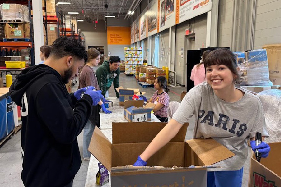 Students pack boxes during the Campus Ministry alternative Spring Break trip.
