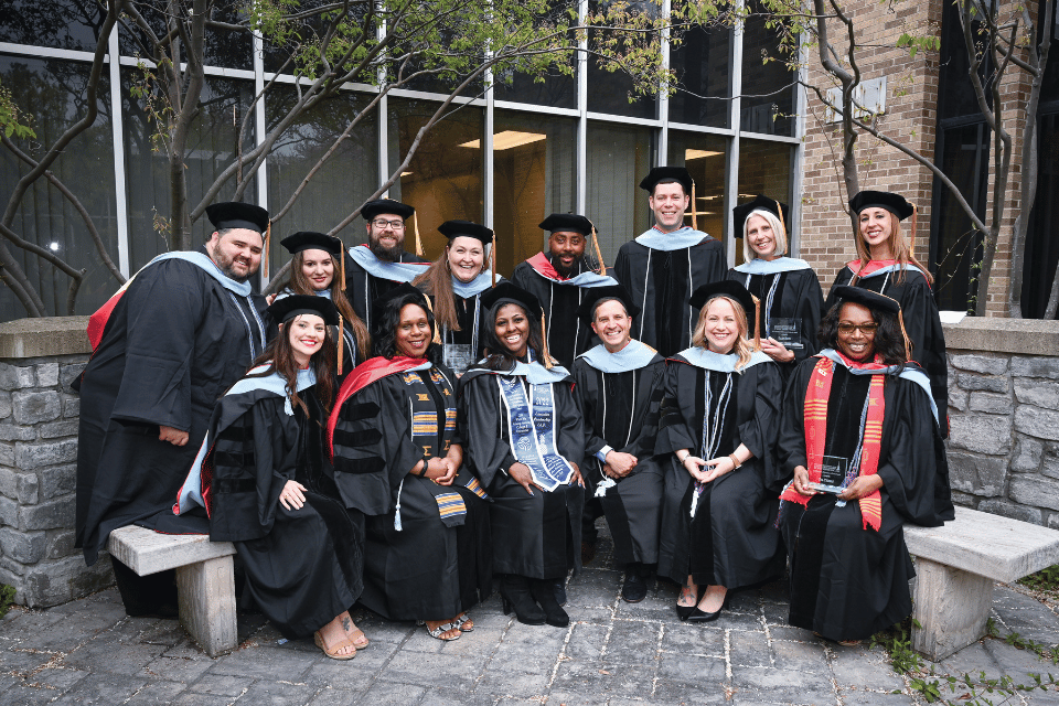 Group of doctorate graduates gathered in academic regalia
