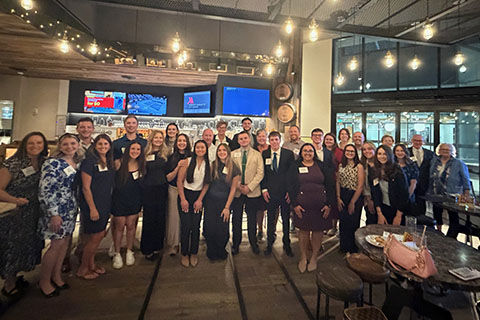 Students at an alumni reception during the Fisher Flight