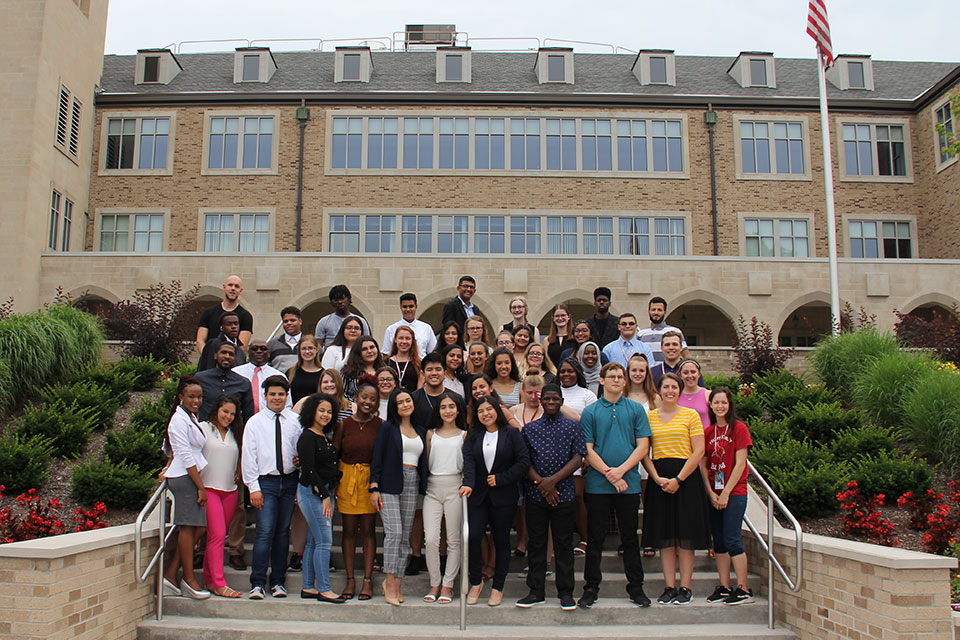 2019 College Bound students and mentors pose as a group on the steps of Kearney Hall.