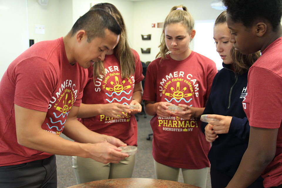 Dr. Ramil Sapinoro (left) taught the students about antibiotics.