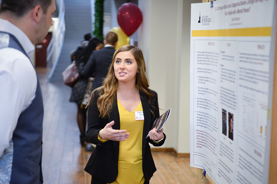A student discusses her research during the annual Research and Creative Works Symposium.