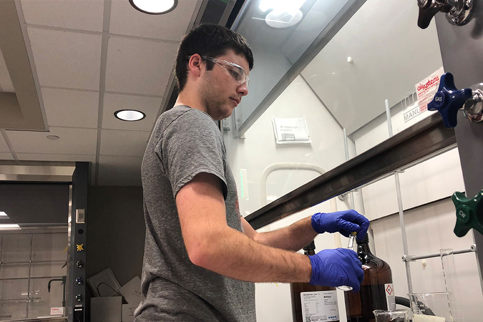Trevor Smith sets up an experiment in the lab as a part of his summer research project.