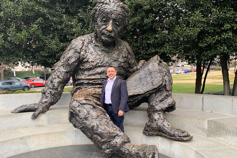 Dr. Martínez-Hernández at the Albert Einstein bronze statue in the grounds of the National Academy of Sciences.