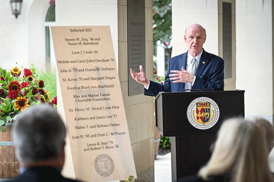 President Gerard J. Rooney shared remarks that celebrated the philanthropic support of each inductee during a ceremony unveiling the addition of the 12 new members to the display of plaques on the columns of Kearney Hall.