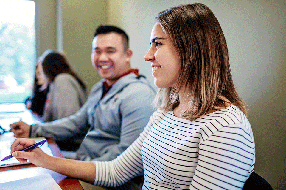 Students interact in a classroom.