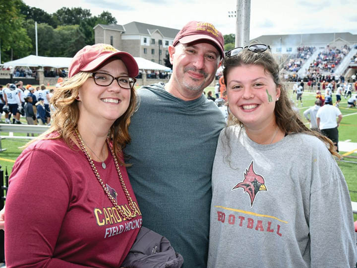 Olivia Rogers with parents at Family Weekend