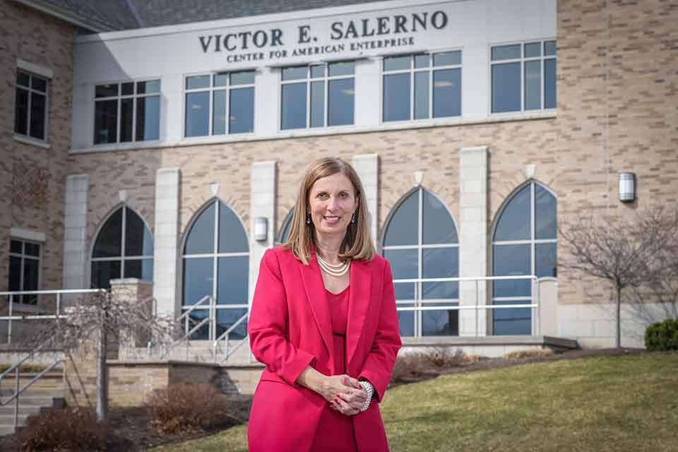 Carol Wittmeyer posing in front of the Salerno Center.