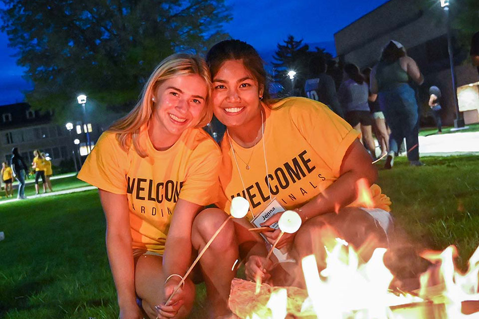 Orientation team members roast marshmallows during Fisher First Night 2021.