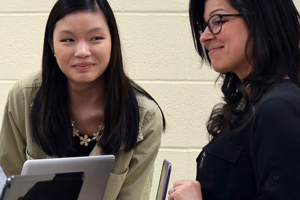 Public relations professor Arien Rozelle chats with a student.