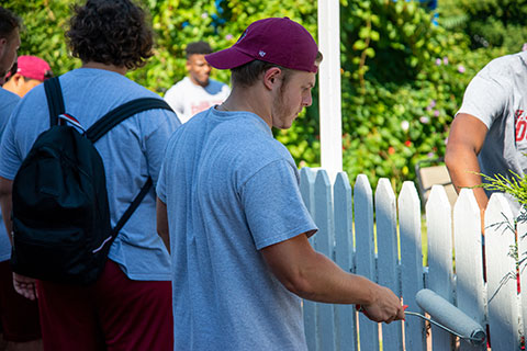 A Bethany House Rochester, football players painted garden fencing and washed windows.