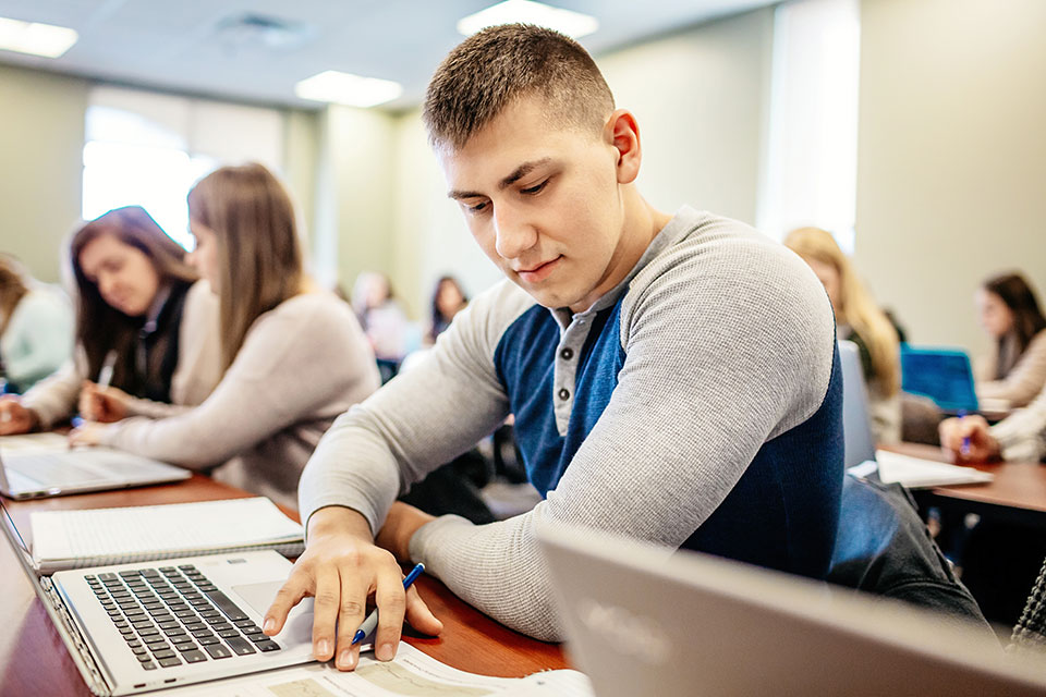 A students take notes during class.