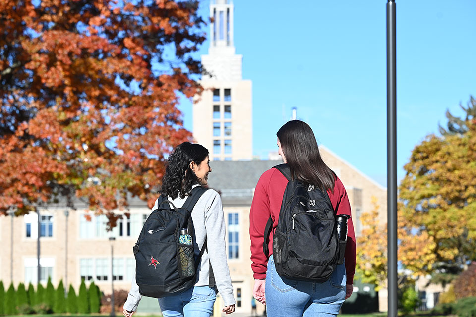 Two students walking through campus.