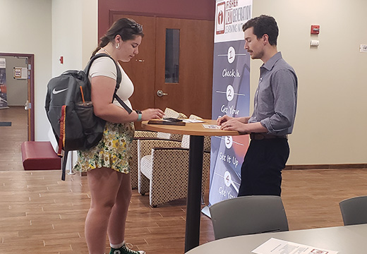 A student uses an iPad at a table.