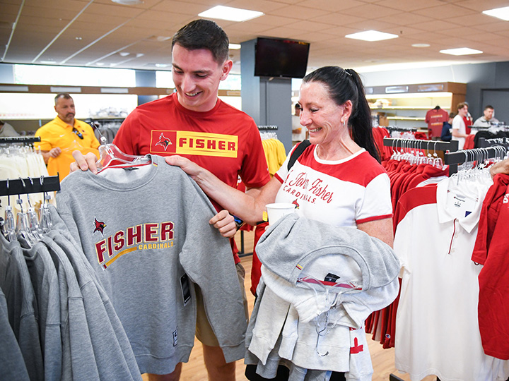 A family shops at the Cardinal Shop store on campus.