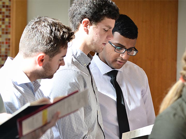 Students sing in the chapel.